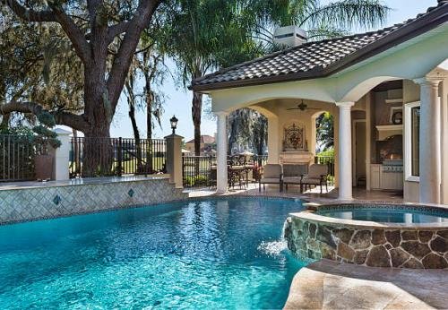 A beautiful custom swimming pool with spa and outdoor living area.